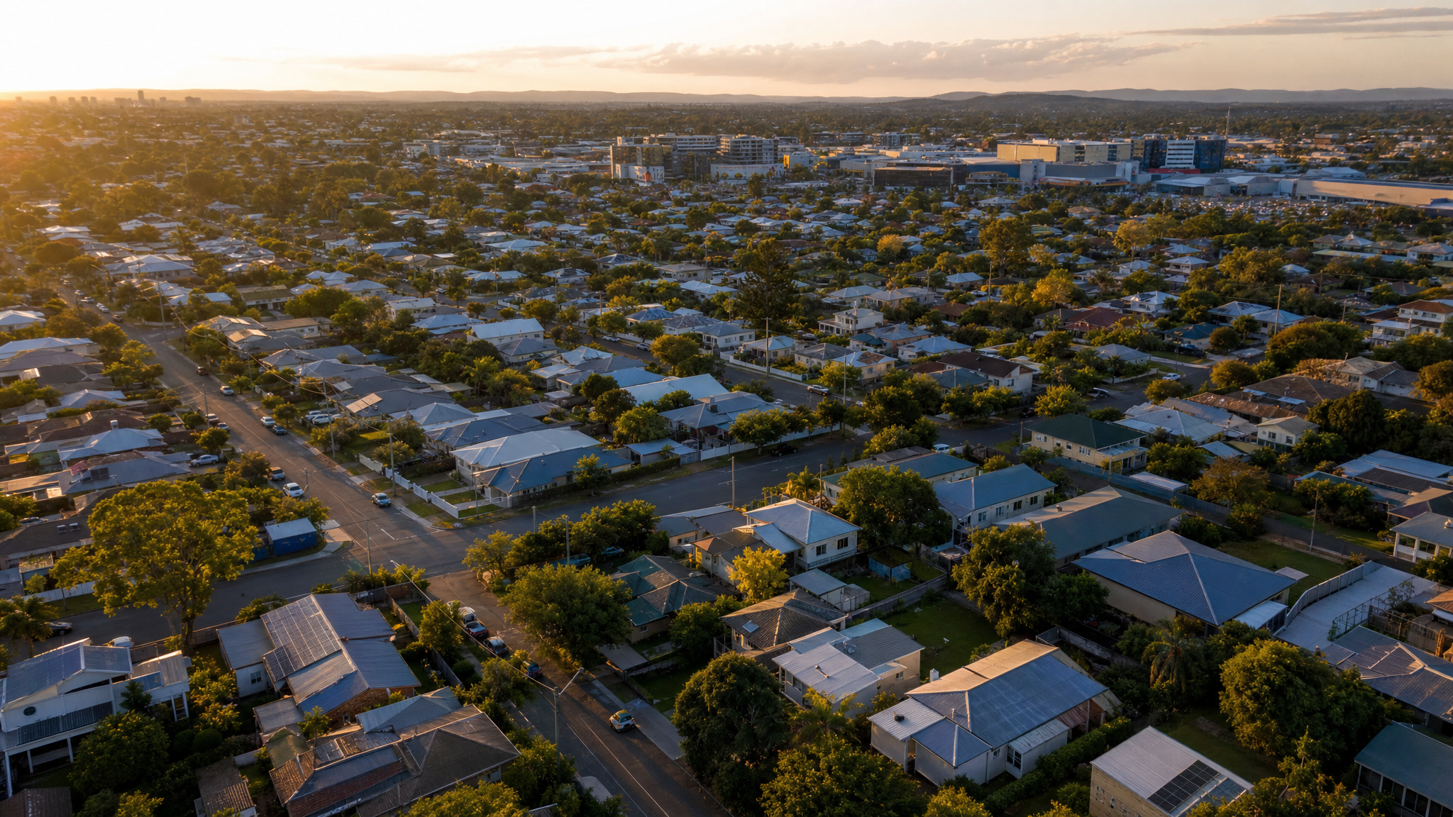 Aerial view of Chermside, Brisbane, with wide suburban grid streets, post-war homes and the large Westfield shopping centre on the horizon